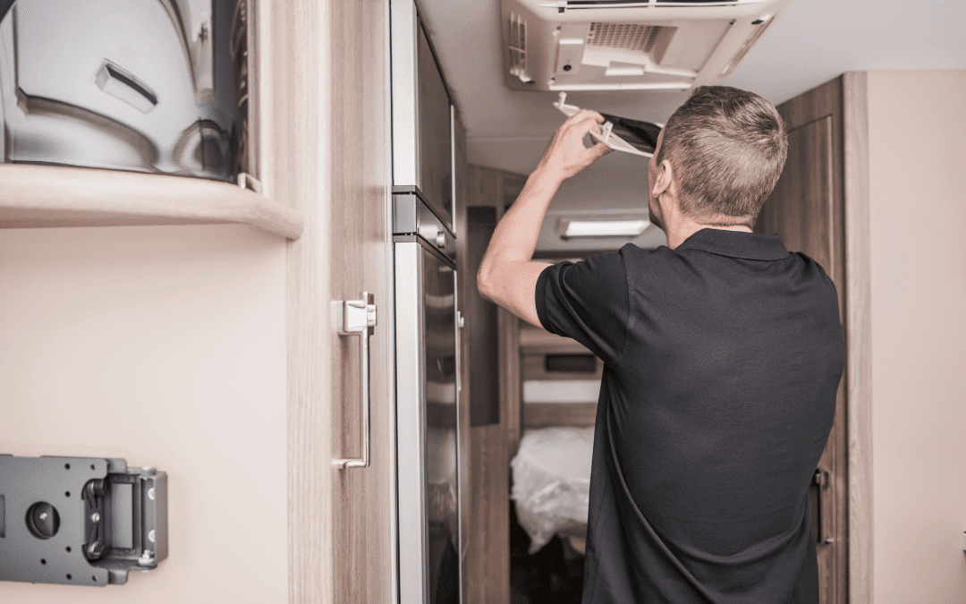 Technician installing ceiling components during custom RV renovation at Ace of Spades Custom RV and Repair in Las Vegas