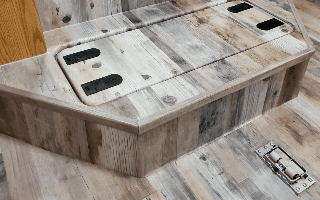 Custom RV flooring with hidden lift-up storage hatch and access panel in wood-look luxury vinyl