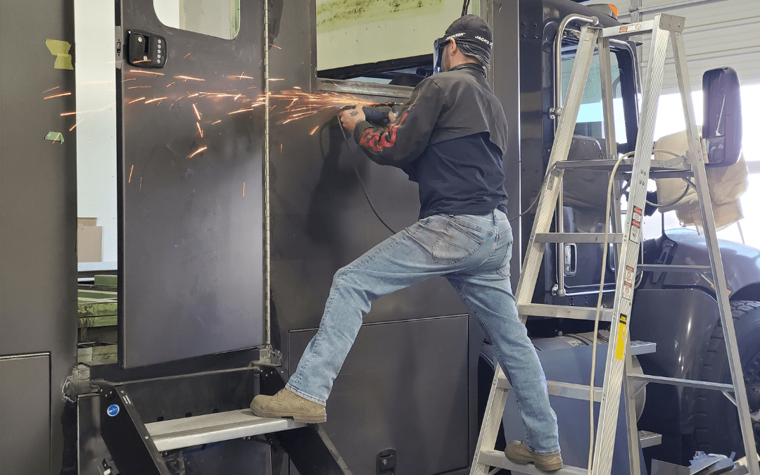 Technician using angle grinder with sparks flying during custom RV bodywork and fabrication at Ace of Spades Custom RV and Repair in Las Vegas