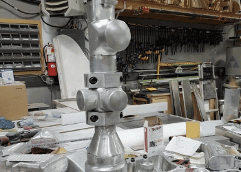 Handcrafted aluminum Barrett 50 Caliber smoke stack components under fabrication for the custom Barrett Truck Peterbilt conversion in the workshop