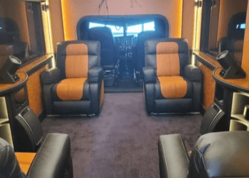 Luxurious Italian leather interior of the Barrett Truck custom 1998 Peterbilt conversion featuring dual captain’s chairs in black and tan